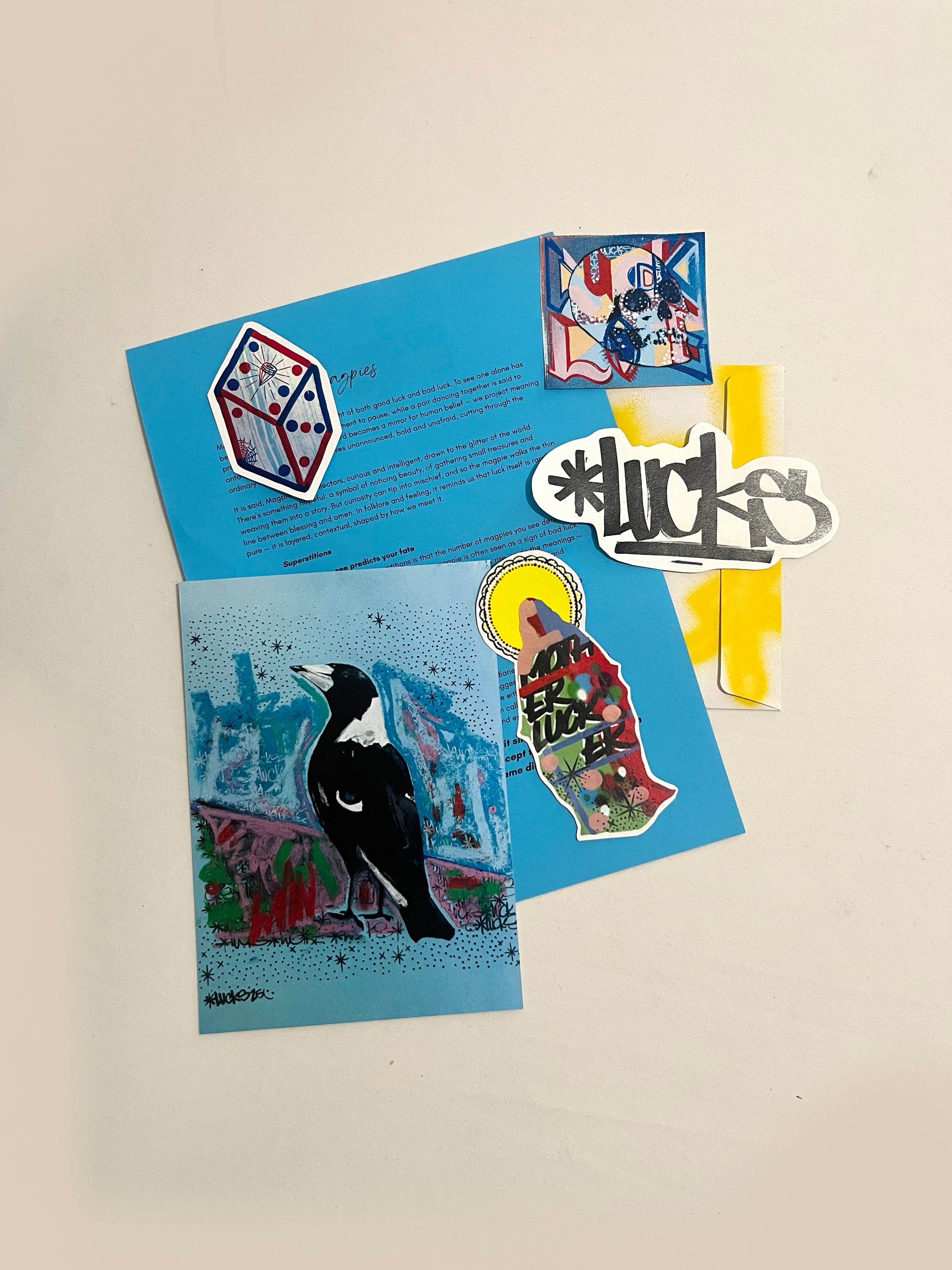 Lucks Mail Art Club art project featuring colorful handmade paper and creative collage elements on a textured background.
